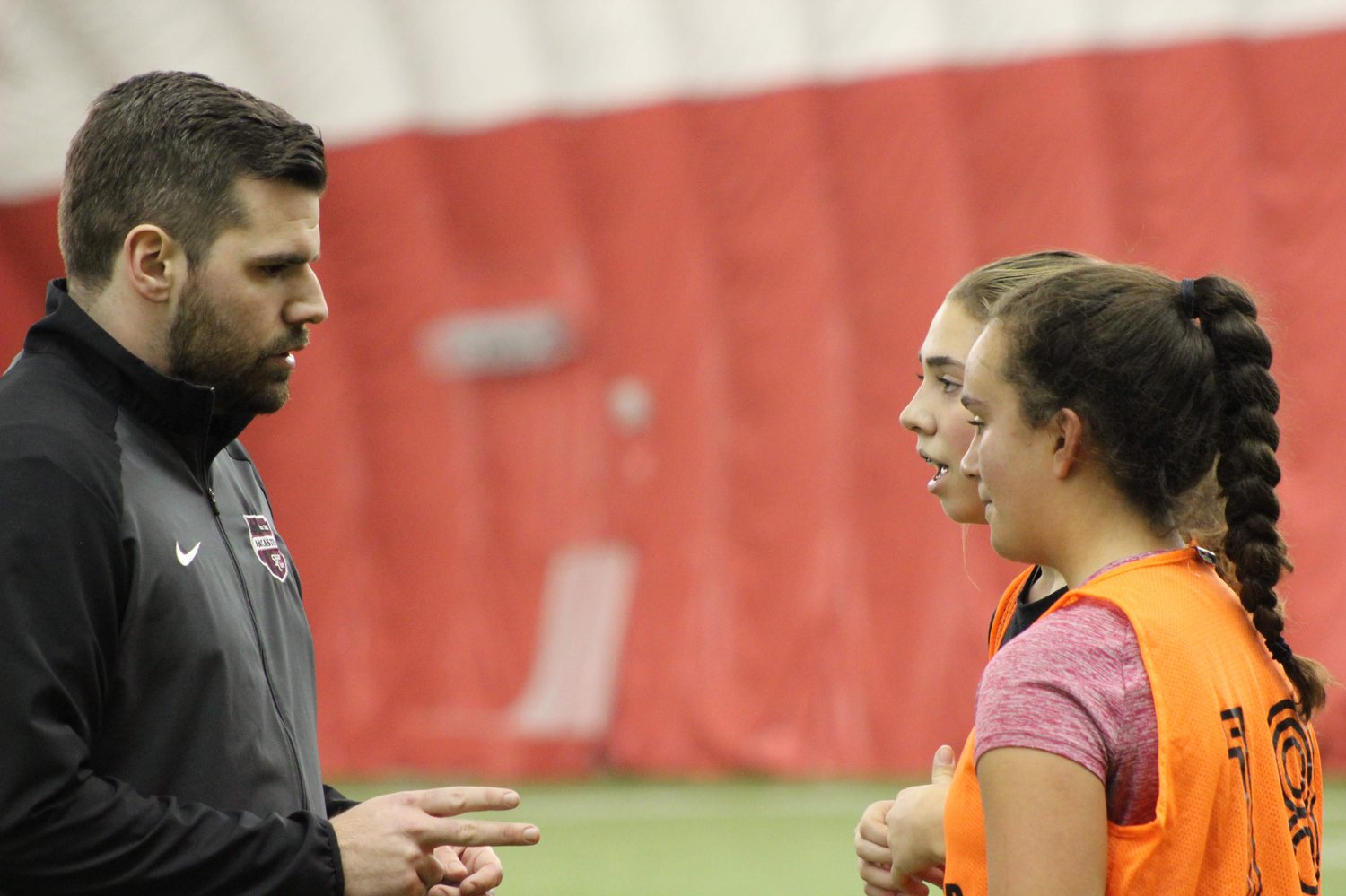 Coaching two players during a training session